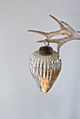 Silver Christmas bauble hanging from antlers