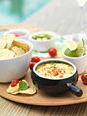 A warm cheese dip with tortilla chips