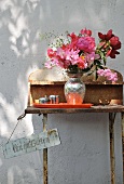 Bouquet on rusty, vintage garden table against exterior wall