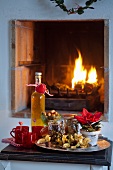 Mulled punch and snacks in front of open fire at Christmas