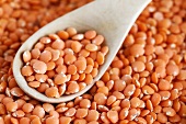 Red lentils in a bowl with a spoon
