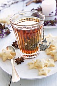 Black tea in a tea glass with a tea egg with star-shaped biscuits