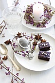 Small wreaths of callicarpa berries with candle and slices of gingerbread