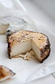 Peppered Aged Goat Cheese Wheel with Wedge Removed
