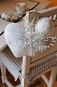 Christmas decorations hanging on chair back