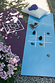 Yoga mats converted into playing boards in the garden