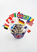A cupcake decorated with various flags