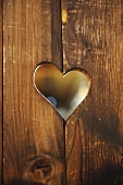 Heart-shaped hole in wooden boards
