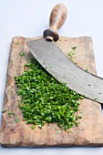 Freshly chopped herbs on cutting board