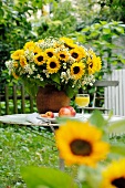 Bunch of flowers and fruit on garden table