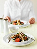 Grilled chicken breast with a vegetables salad on a table