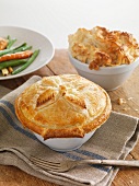 Two chicken pies in pie dishes