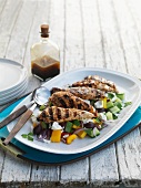Grilled chicken breast on a bed of Greek salad