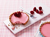 Raspberry tartlets, one with a bite taken out