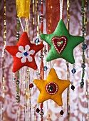 Fabric hearts and strings of beads as Christmas decorations