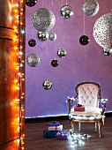 Upholstered chair with fairy lights, Christmas baubles and presents