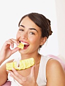 Woman eating pineapple