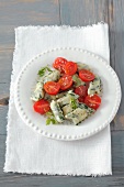 Potato and spinach dumplings with cherry tomatoes