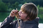 A boy eating stick bread