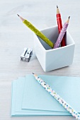 Pencils decorated with colourful patterned tape in white china pot