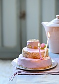 A three-tier cake with candles