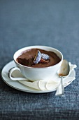 Chocolate Mousse in a Tea Cup with Sugared Plum Garnish; Bite Taken Out; Spoon