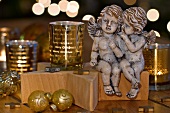 Pair of Christmas angels and gold, glass tea light holders