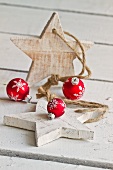 Red Christmas baubles and wooden stars