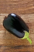 An aubergine on a wooden surface