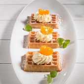 Waffle topped with mandarins and cream