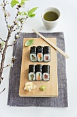 Various maki sushi and matcha tea