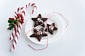 Chocolate star-shaped biscuits with candy canes
