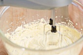 Buttercreme being mixed with an electric whisk