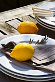Lemons and stacked plates on rustic table