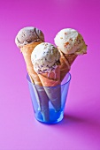 Three ice cream cones with various ice cream flavours