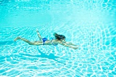 Woman in bikini swimming in pool