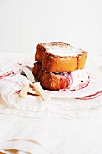Blackberry and Mascarpone Stuffed French Toast Made with Brioche; On a Plate with Knife and Fork