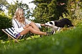 Woman playing with dog in garden