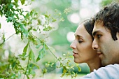 Couple looking at tree, close-up