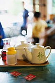 Tray with tea service and table markers on table in restaurant