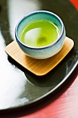 Cup of green tea with sediment in bottom