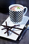 Cocoa with milk foam and mint and chocolate sticks
