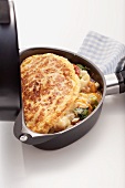 An omelette with a spicy filling in an omelette maker