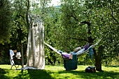 Relaxing in hammock in Mediterranean garden