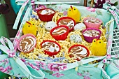 Desserts in colourful cases and Easter decorations in fabric-covered box