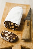 Chocolate salami with nuts and icing sugar