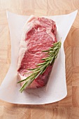 Rump steak with rosemary on a piece of paper