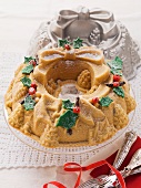 A Christmas wreath cake with the baking tin in the background