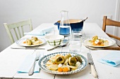 A table laid with artichoke dishes
