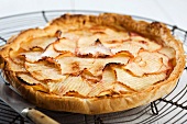 Nectarine and apple tart on a wire rack